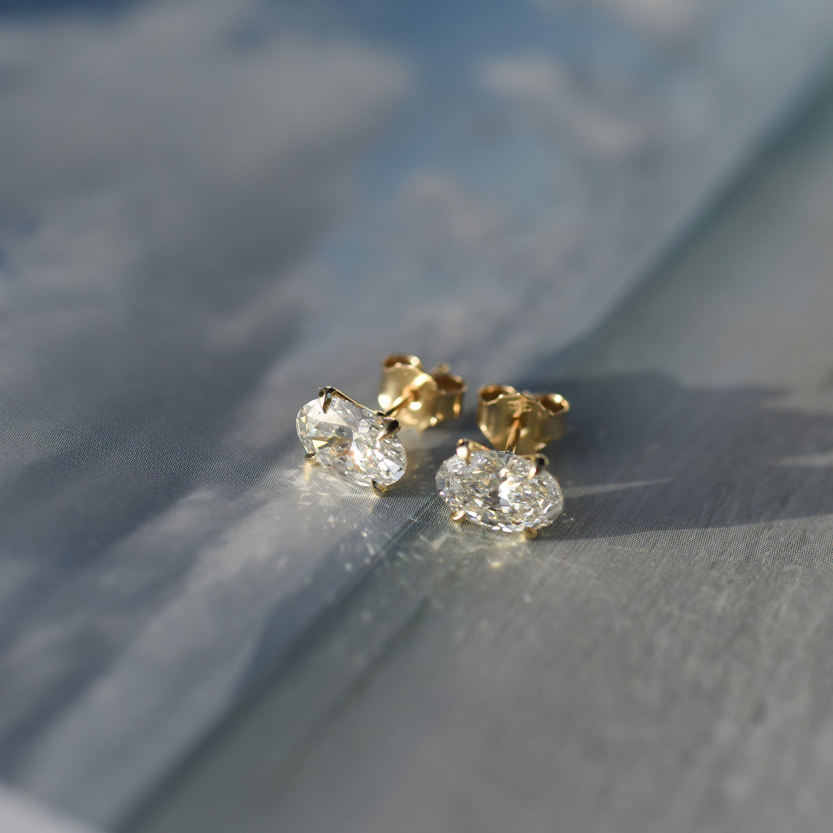 SOLENNE oval-cut diamond stud earrings in yellow gold, photograph 2